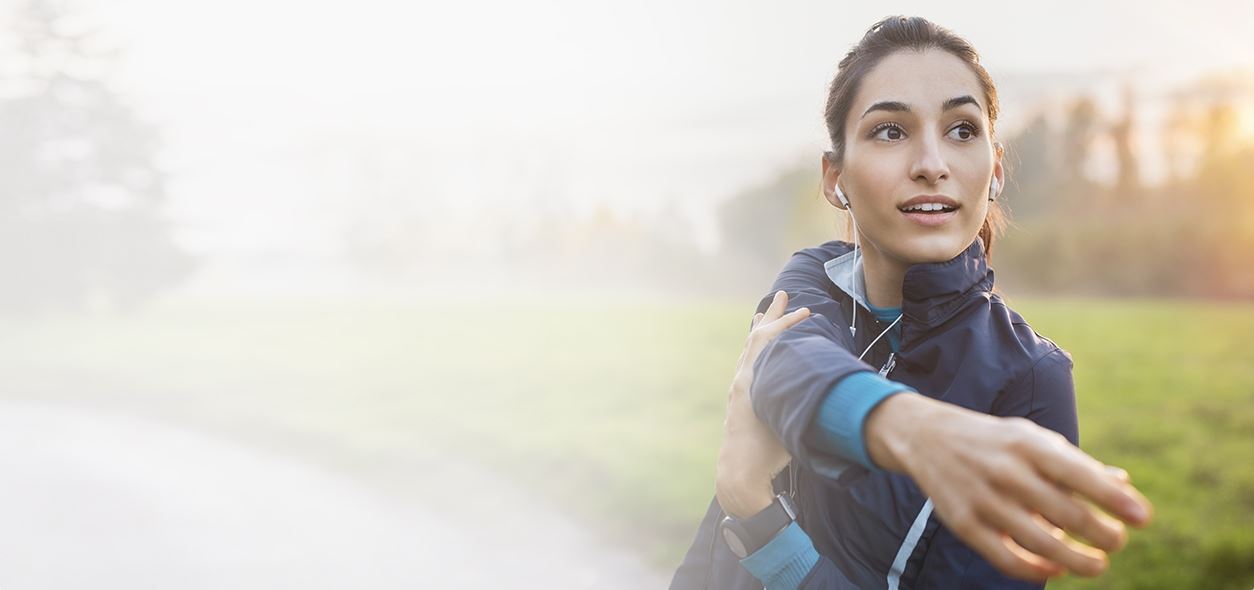 Lady stretching arms before a run